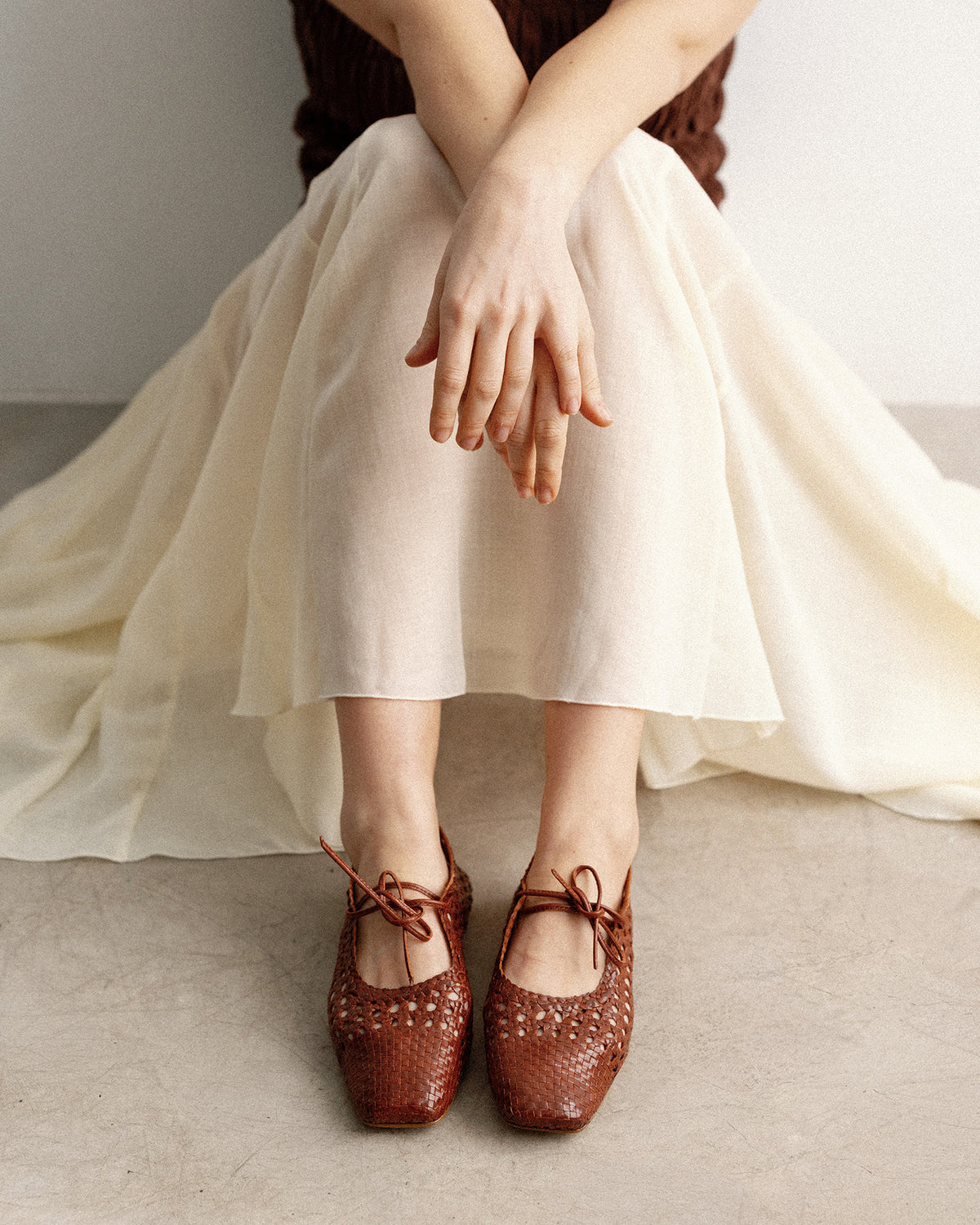 Flat shoes with a terracotta-colored mesh pattern
