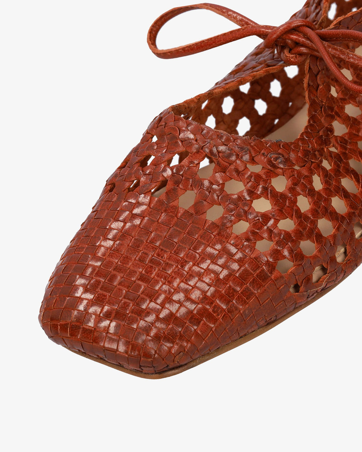 Flat shoes with a terracotta-colored mesh pattern
